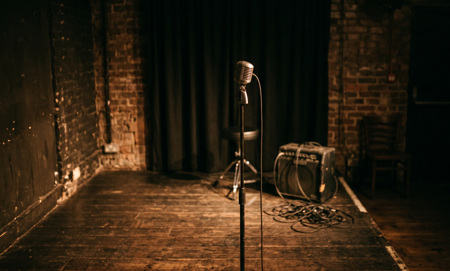 Artist performing on a small venue stage